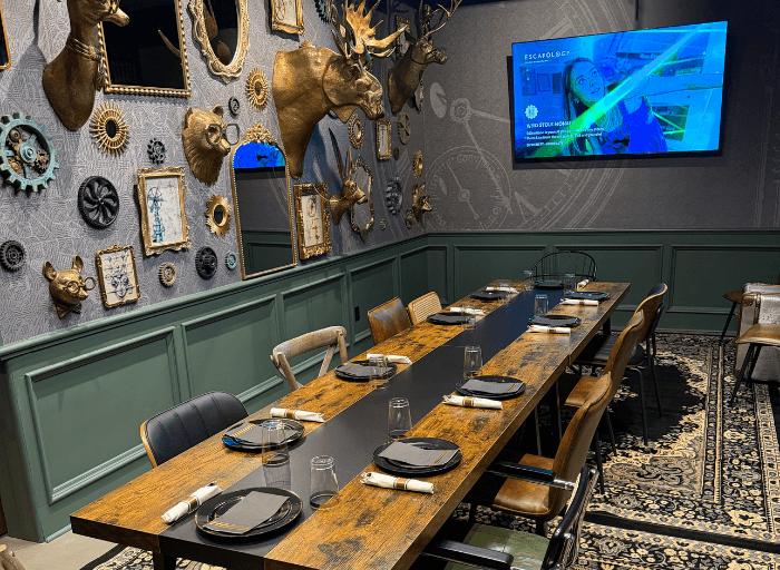 Escapology Party Room with eclectic steampunk decor and a long table set for a birthday event